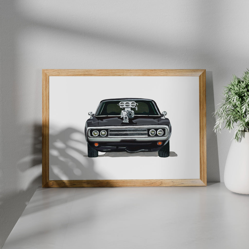 Framed black Dodge Charger R/T art print shown at an angle on a white surface