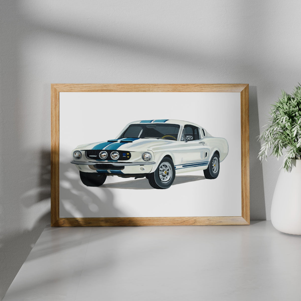 Framed white Ford Mustang GT500 art print shown at an angle on a white surface