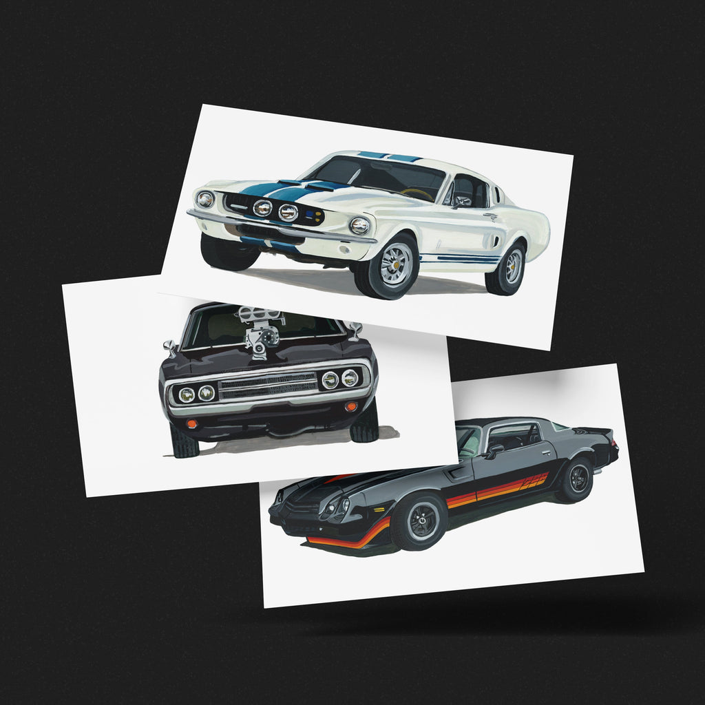 Ford Mustang GT500, Chevrolet Camaro Z28 and Dodge Charger R/T art prints fanned out on a black background