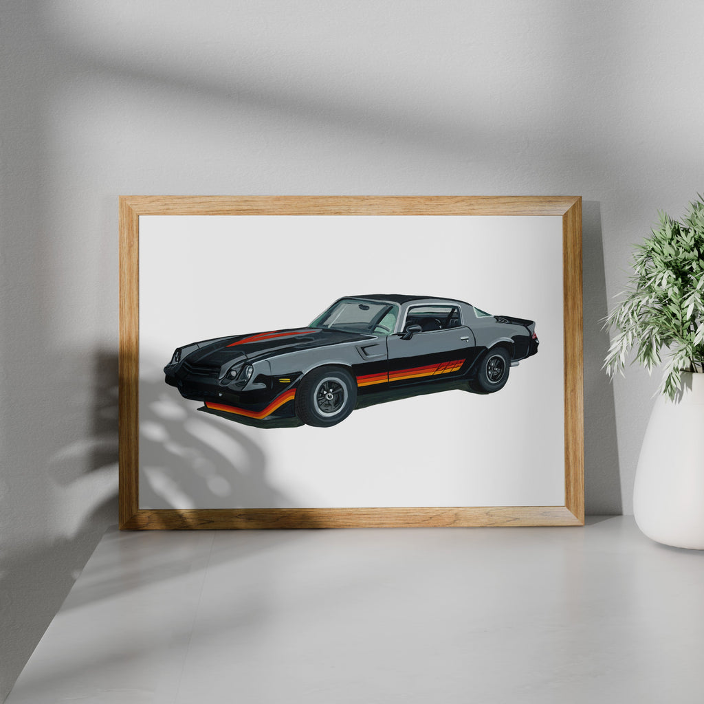 Framed black Chevrolet Camaro Z28 art print shown at an angle on a white surface