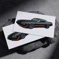 Two black Chevrolet Camaro Z28 art prints resting on a dark stone surface