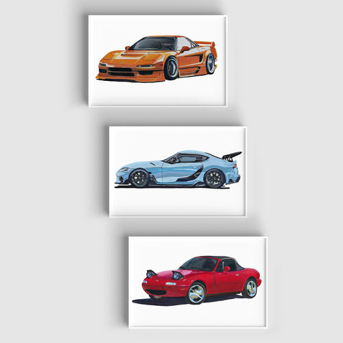 The three JDM car art prints staggered vertically on a pale wall