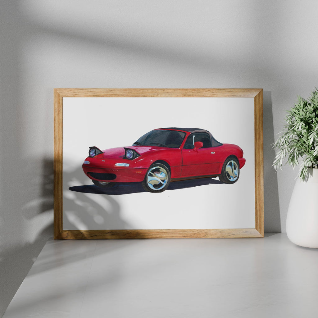 Red sports car art print in a wooden frame beside a potted plant