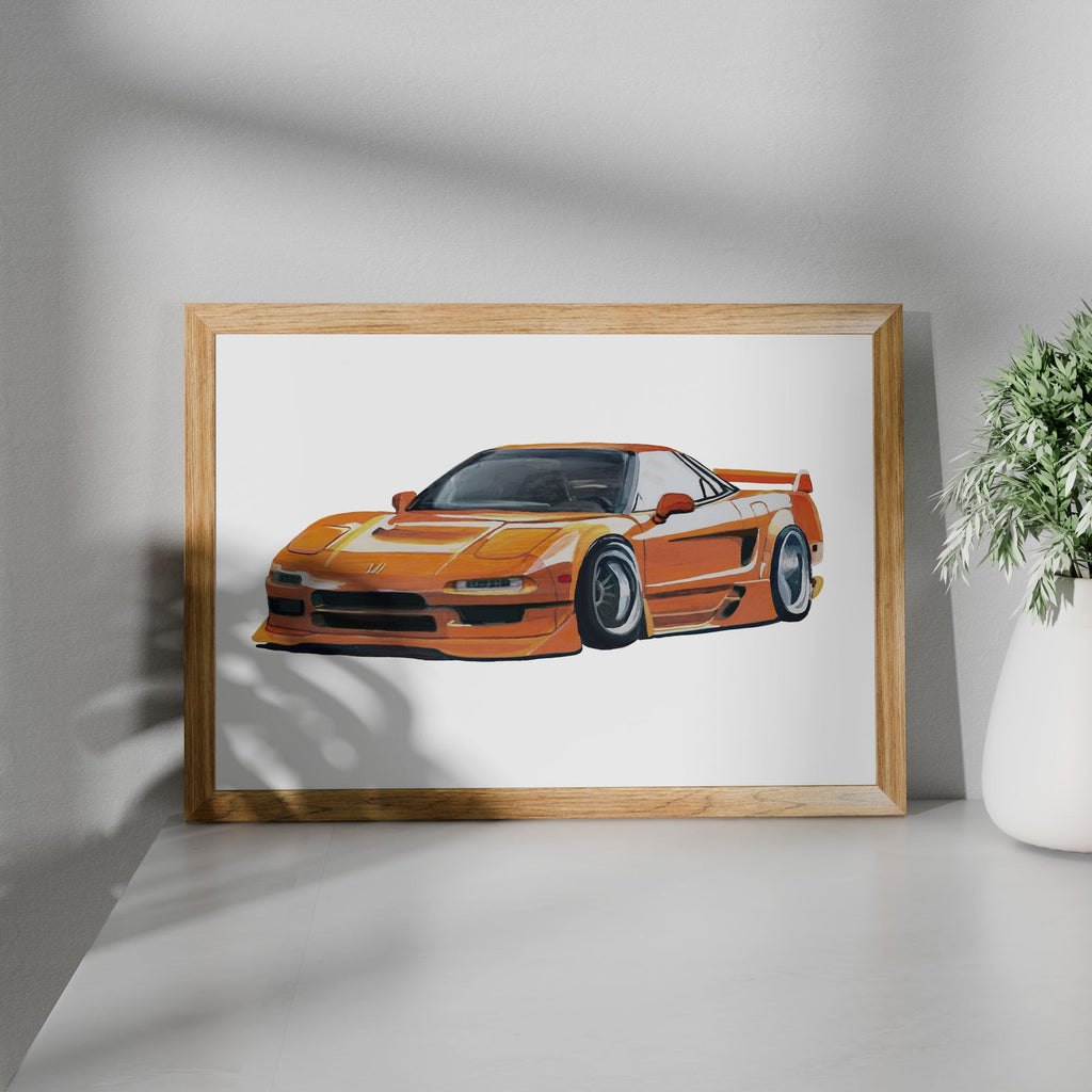 Orange sports car art print in a wooden frame beside a potted plant