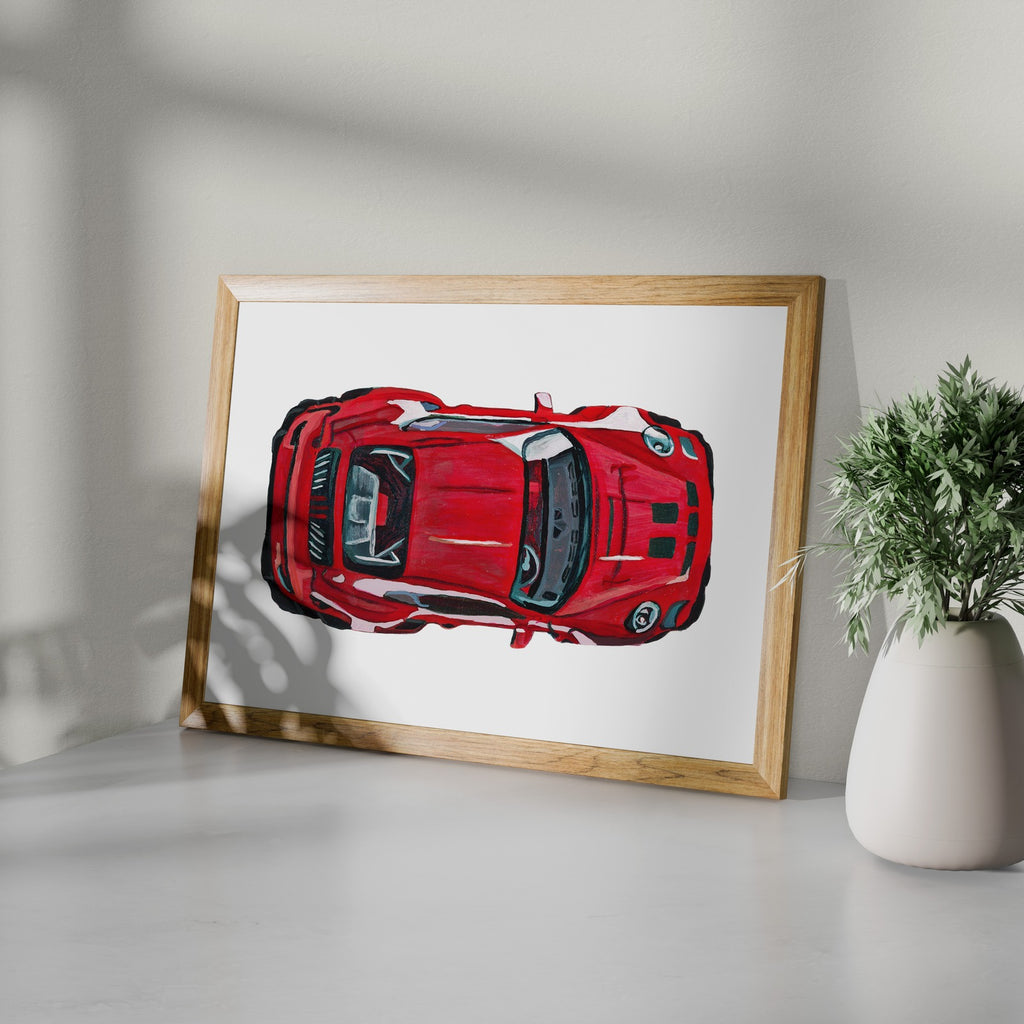 Framed red sports car art print styled on a white shelf