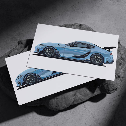 Two light blue sports car art prints resting on a dark stone surface